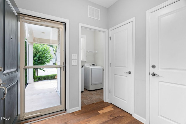 1019 Santiago St, Durham, NC 27703 - foyer with washer / dryer and wood finished floors