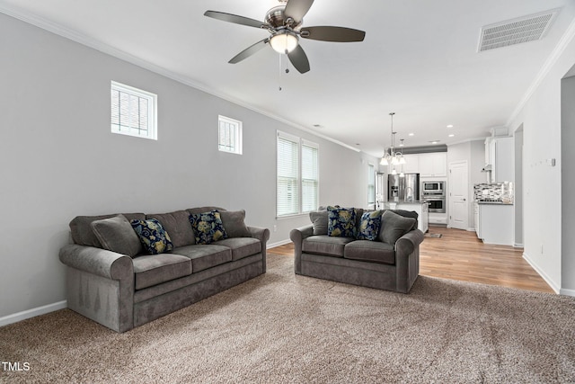 1019 Santiago St, Durham, NC 27703 - living area featuring crown molding, light colored carpet, ceiling fan, and recessed lighting