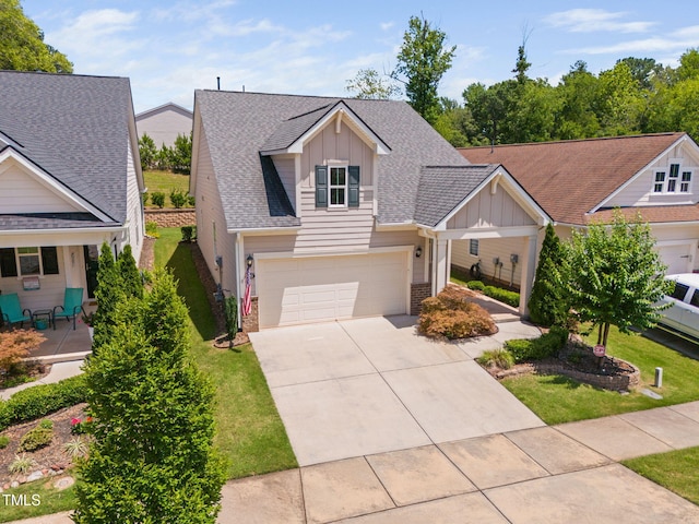 1019 Santiago St, Durham, NC 27703 - view of front facade featuring board and batten siding, driveway, roof with shingles, and a front yard