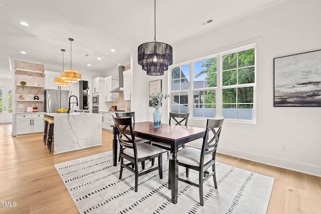 525 Kings Lake Way, Durham, NC 27703 - dining area with a chandelier, healthy amount of natural light, light wood-style flooring, and recessed lighting