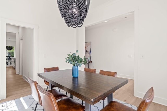 525 Kings Lake Way, Durham, NC 27703 - dining area with a chandelier and light wood finished floors
