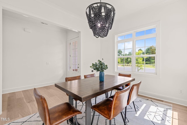 525 Kings Lake Way, Durham, NC 27703 - dining space featuring a chandelier, light wood finished floors, and ornamental molding