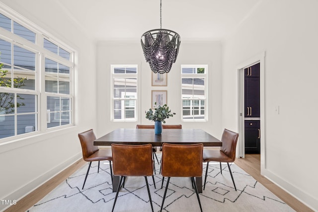 525 Kings Lake Way, Durham, NC 27703 - dining area with a chandelier, light wood-style flooring, and ornamental molding