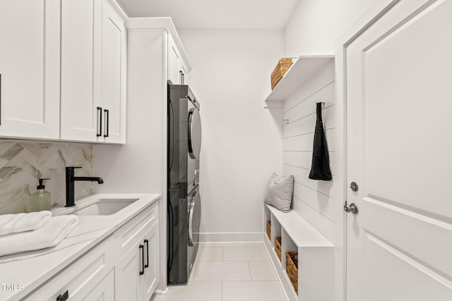 525 Kings Lake Way, Durham, NC 27703 - laundry room featuring cabinet space, stacked washing machine and dryer, and light tile patterned floors