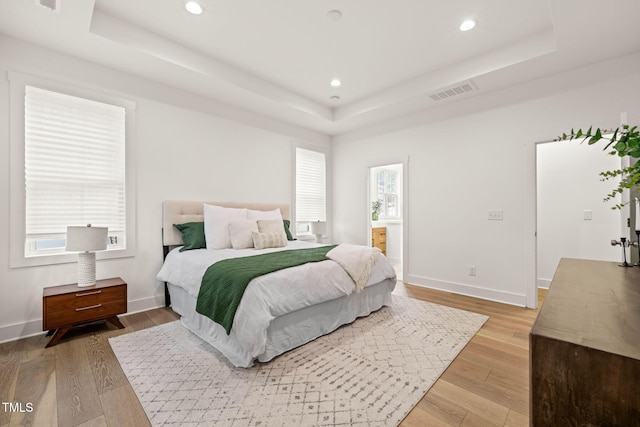 525 Kings Lake Way, Durham, NC 27703 - bedroom with a tray ceiling, light wood finished floors, and recessed lighting