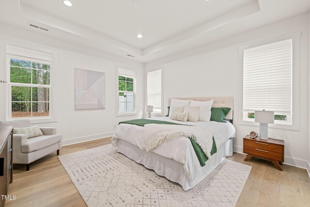 525 Kings Lake Way, Durham, NC 27703 - bedroom with a tray ceiling, light wood-style floors, multiple windows, and recessed lighting