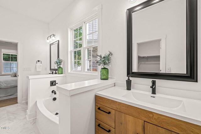 525 Kings Lake Way, Durham, NC 27703 - ensuite bathroom with marble finish flooring, vanity, and a bath