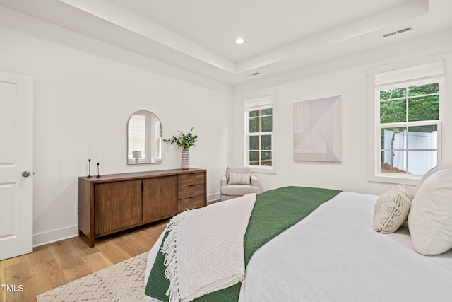 525 Kings Lake Way, Durham, NC 27703 - bedroom with a tray ceiling, multiple windows, light wood-type flooring, and recessed lighting
