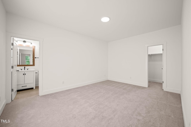 525 Kings Lake Way, Durham, NC 27703 - unfurnished bedroom featuring light colored carpet, a spacious closet, a closet, and connected bathroom