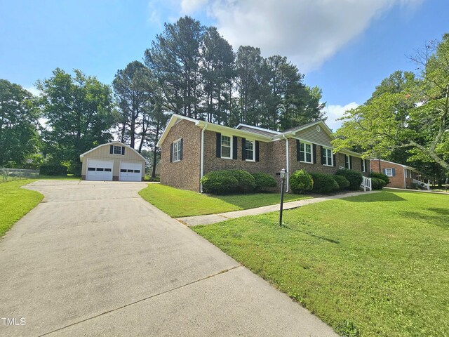 112 Saddletree Rd, Oxford, NC 27565 - ranch-style home featuring a detached garage, an outbuilding, a front yard, and brick siding