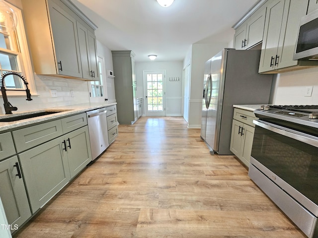 112 Saddletree Rd, Oxford, NC 27565 - kitchen with stainless steel appliances, light wood-type flooring, decorative backsplash, and gray cabinetry
