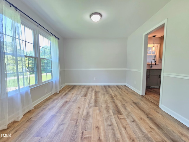 112 Saddletree Rd, Oxford, NC 27565 - spare room with light wood-style floors and a chandelier