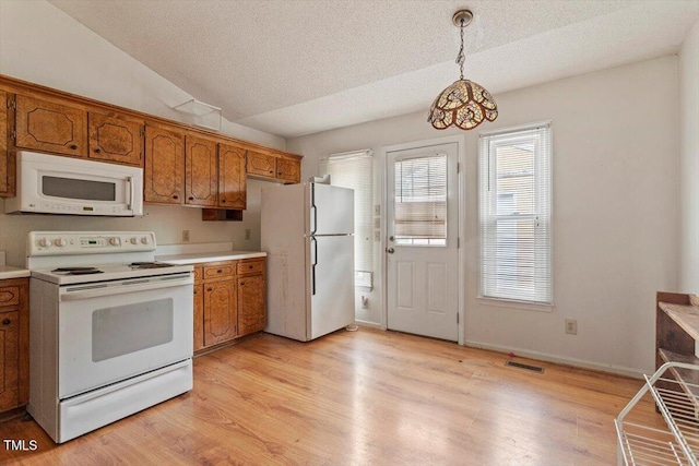 34 Scotts Creek Run, Angier, NC 27501 - kitchen featuring white appliances, brown cabinets, light countertops, decorative light fixtures, and a textured ceiling