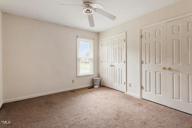 34 Scotts Creek Run, Angier, NC 27501 - unfurnished bedroom featuring carpet floors, two closets, a ceiling fan, and a textured ceiling