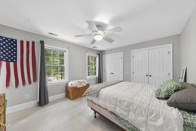 821 Ascot Ln, Raleigh, NC 27615 - bedroom featuring multiple closets, light wood finished floors, and a ceiling fan