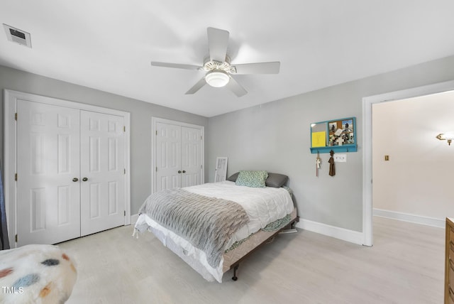 821 Ascot Ln, Raleigh, NC 27615 - bedroom with light wood finished floors, multiple closets, and ceiling fan