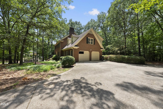 821 Ascot Ln, Raleigh, NC 27615 - view of side of property with a garage, a chimney, driveway, and brick siding