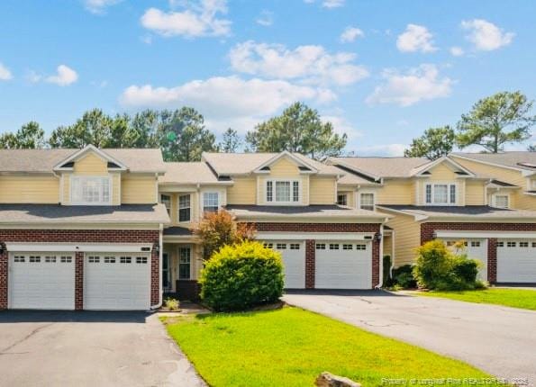 82 Pine Hawk Dr, Spring Lake, NC 28390 - view of front of home featuring a garage, driveway, and brick siding