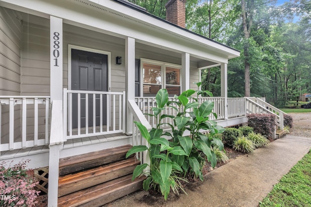 8801 Valley Hill Ct, Apex, NC 27539 - entrance to property with a chimney and covered porch