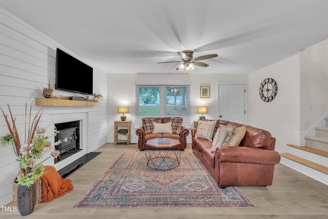 8801 Valley Hill Ct, Apex, NC 27539 - living area featuring ceiling fan, stairway, wood finished floors, and a large fireplace