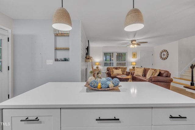 8801 Valley Hill Ct, Apex, NC 27539 - kitchen with light countertops, white cabinets, hanging light fixtures, ceiling fan, and open floor plan