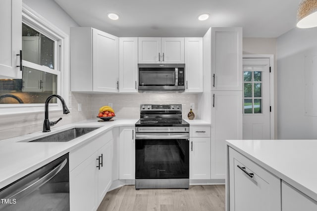 8801 Valley Hill Ct, Apex, NC 27539 - kitchen featuring stainless steel appliances, light countertops, white cabinetry, and recessed lighting