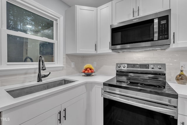 8801 Valley Hill Ct, Apex, NC 27539 - kitchen with stainless steel appliances, backsplash, white cabinetry, and light countertops