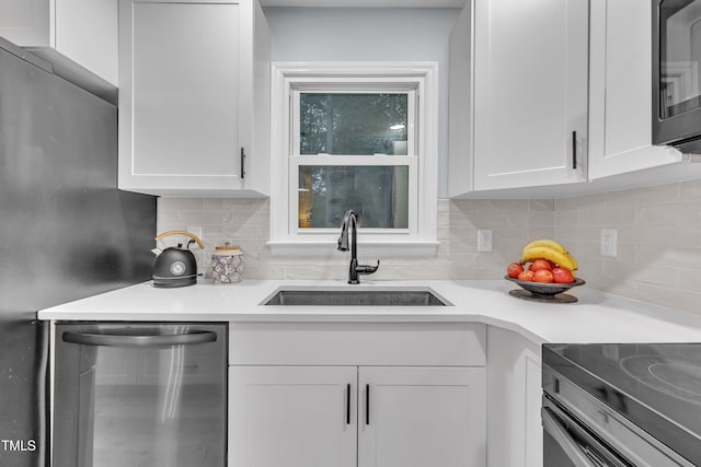 8801 Valley Hill Ct, Apex, NC 27539 - kitchen featuring stainless steel appliances, white cabinets, light countertops, and backsplash