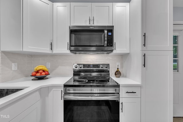 8801 Valley Hill Ct, Apex, NC 27539 - kitchen with stainless steel range with electric stovetop, white cabinets, light countertops, and decorative backsplash
