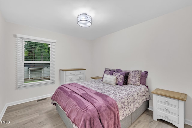 8801 Valley Hill Ct, Apex, NC 27539 - bedroom with light wood-style floors and baseboards