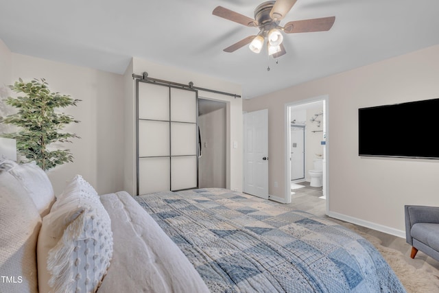 8801 Valley Hill Ct, Apex, NC 27539 - bedroom featuring a barn door, a ceiling fan, and ensuite bath