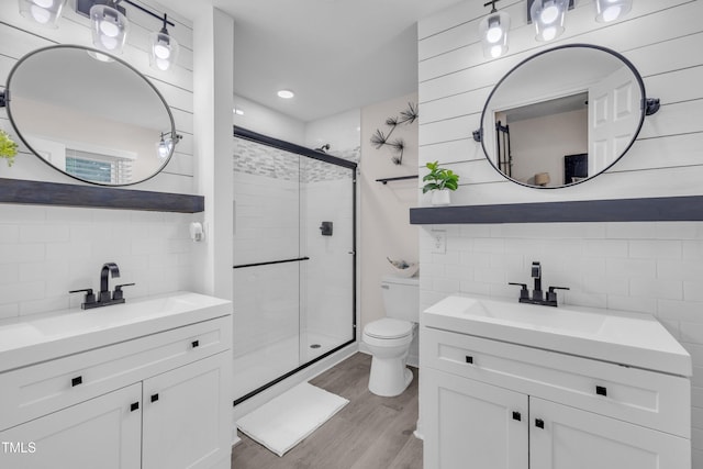8801 Valley Hill Ct, Apex, NC 27539 - full bath featuring tasteful backsplash, a shower stall, wood finished floors, and two vanities