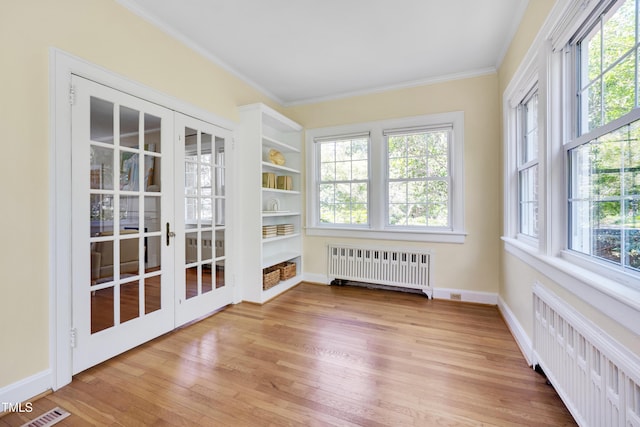 1007 W Markham Ave, Durham, NC 27701 - unfurnished sunroom with radiator heating unit and french doors