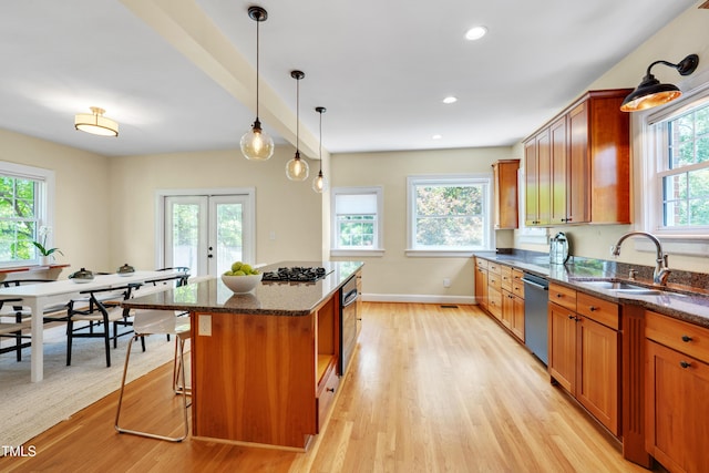 1007 W Markham Ave, Durham, NC 27701 - kitchen featuring stainless steel dishwasher, light wood finished floors, dark stone countertops, and recessed lighting