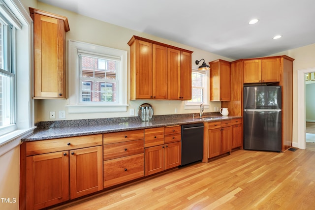 1007 W Markham Ave, Durham, NC 27701 - kitchen featuring freestanding refrigerator, dishwasher, light wood-style flooring, brown cabinets, and recessed lighting