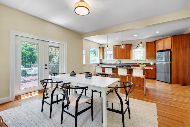 1007 W Markham Ave, Durham, NC 27701 - dining space featuring light wood-style floors, french doors, and recessed lighting