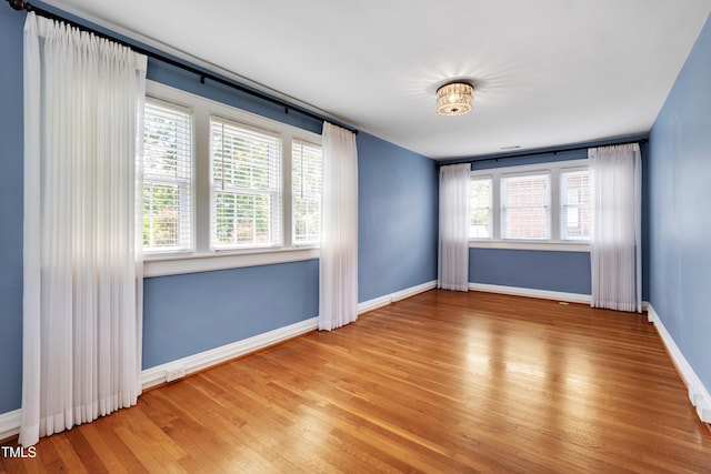 1007 W Markham Ave, Durham, NC 27701 - empty room with wood finished floors and baseboards