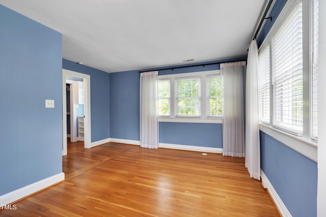 1007 W Markham Ave, Durham, NC 27701 - empty room featuring light wood-style flooring and healthy amount of natural light
