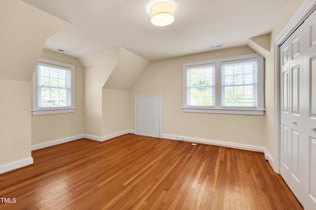 1007 W Markham Ave, Durham, NC 27701 - additional living space featuring light wood-style flooring and vaulted ceiling