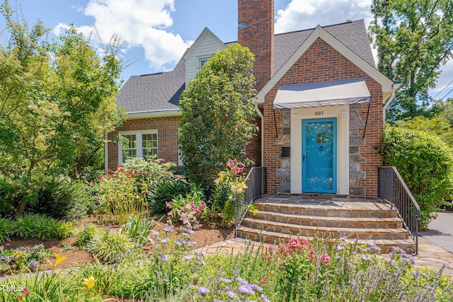 1007 W Markham Ave, Durham, NC 27701 - view of front of house with a chimney, brick siding, and a shingled roof