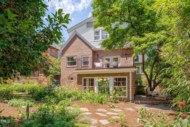 1007 W Markham Ave, Durham, NC 27701 - rear view of house with brick siding, a balcony, and a deck