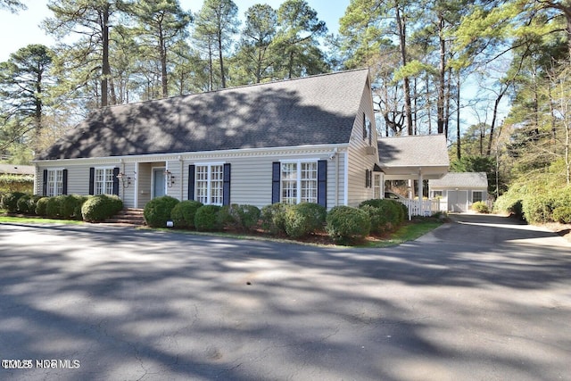 322 Gravley Dr, Rocky Mount, NC 27804 - cape cod house featuring roof with shingles, a porch, and driveway