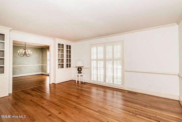 322 Gravley Dr, Rocky Mount, NC 27804 - spare room featuring a chandelier, wood finished floors, and ornamental molding
