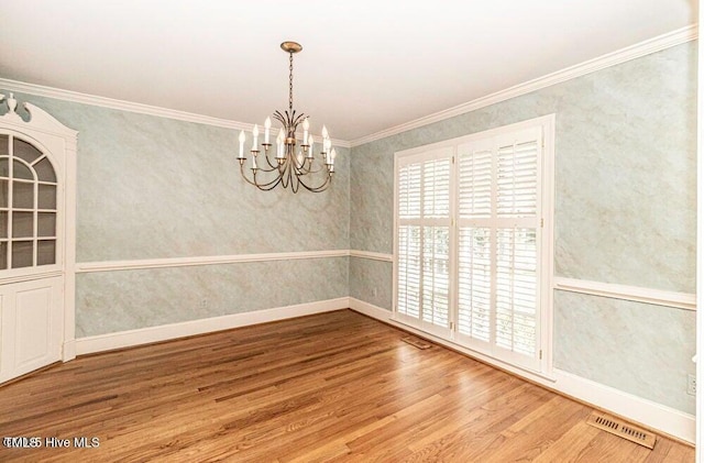 322 Gravley Dr, Rocky Mount, NC 27804 - unfurnished room with wood finished floors, a chandelier, ornamental molding, and wallpapered walls