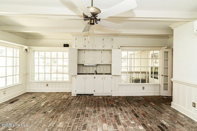 322 Gravley Dr, Rocky Mount, NC 27804 - unfurnished living room with brick flooring, a ceiling fan, healthy amount of natural light, beam ceiling, and a decorative wall