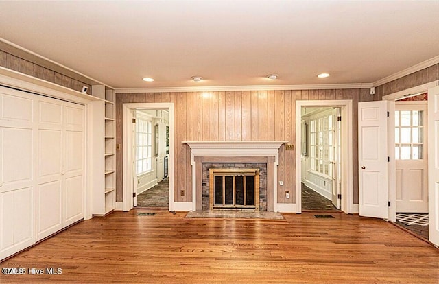 322 Gravley Dr, Rocky Mount, NC 27804 - unfurnished living room featuring ornamental molding, wood finished floors, a premium fireplace, recessed lighting, and wooden walls