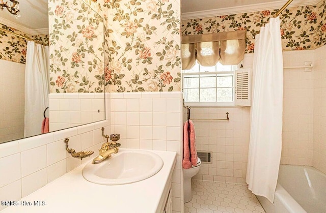 322 Gravley Dr, Rocky Mount, NC 27804 - bathroom featuring crown molding, wallpapered walls, tile walls, wainscoting, and vanity