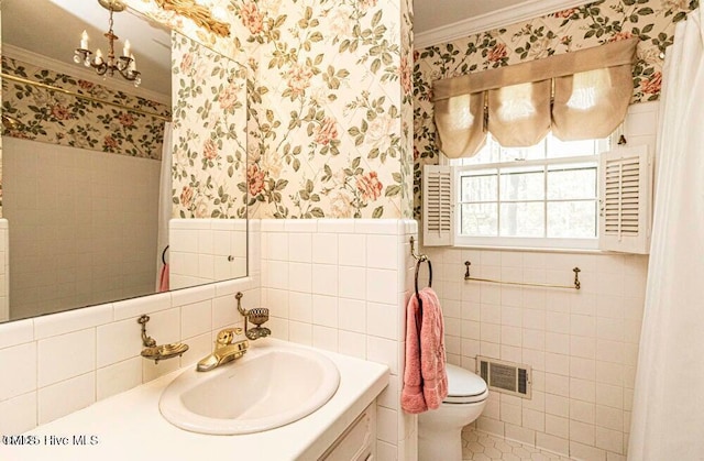 322 Gravley Dr, Rocky Mount, NC 27804 - bathroom featuring ornamental molding, wallpapered walls, tile walls, vanity, and wainscoting
