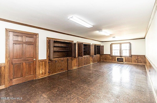 322 Gravley Dr, Rocky Mount, NC 27804 - empty room featuring a wainscoted wall, wooden walls, and ornamental molding