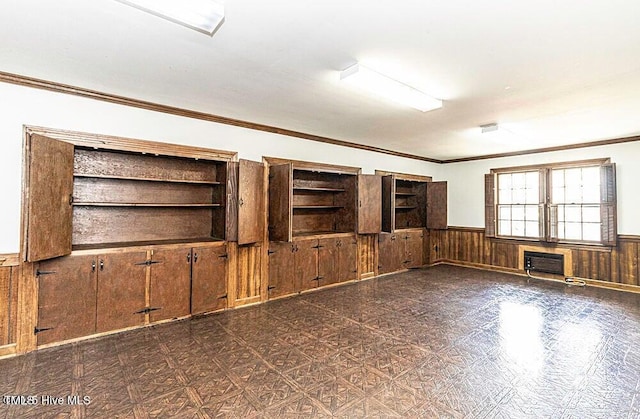 322 Gravley Dr, Rocky Mount, NC 27804 - unfurnished living room with wainscoting, crown molding, wooden walls, and a wall unit AC